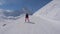 Skier Woman Slowly Skiing Down On Ski Slope In Mountain