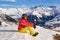 Skier woman taking a break above Saint-Jean-d`Arves village, France, in Les Sybelles ski resort, admiring the sunset.