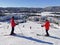 Skiers admiring Mont and Lake Tremblant village resort in winter