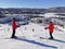 Skiers admiring Mont and Lake Tremblant village resort in winter, Quebec