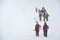 Skiers carries skis and equipment to the track on a slope for skiing on Mount Asahi Asahidake mountain during snowfall