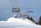 Skiers in chairlift arriving to top of mountain