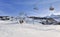 Skiers on chairlifts in alpine resort at winter sports