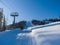 Skiers climb the mountain on a special ski lift. Winter sunny day