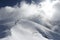 Skiers climbing a snowy mountain