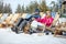 Skiers couple in sun lounger enjoy on sun