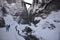 skiers descend into the narrow canyon