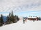 The skiers in front of small t-bar lift and cafe