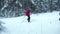 Skiers glide quickly on the track in the forest