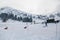 Skiers and kids driving in sledge at snowy ski slope enjoying winter holidays at Kalavryta ski Resort in Greece.