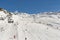 Skiers on a piste in alpine ski resort