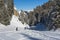 Skiers on a piste in alpine ski resort