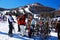 Skiers place their skis on a rack to take a break from the slopes