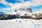 Skiers riding on the ski slope in winter Dolomites, Italy