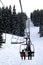 Skiers Riding Up a Chair Lift