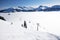 Skiers on ski lift enjoying the view to foggy Alps in Austria and beautiful snowy country panorama in famous Kitzbuehel mountain