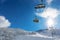 Skiers in a ski lift in snowy mountains