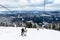 Skiers on ski lift to mountain Zakhar Berkut, Carpathian mountains in Slavske, Ukraine