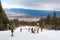 Skiers on the slope , ski lift, mountains view and Bansko panorama, Bulgaria