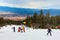 Skiers on the slope , ski lift, mountains view and Bansko panorama, Bulgaria