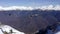 Skiers and snowboarders on chairlift at rope way in winter resort in mountain