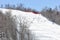 Skiers and snowboarders going down the slope