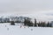 Skiers and snowboarders going down slopes of Whistler Blackcomb