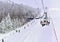 Skiers and snowboarders are lifting on ski-lift. Downhill ride. Adventure skiers season. Skiing and Snowboarding Resorts. Ski and