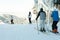 Skiers and snowboarders making downhill ride from the top of a mountain