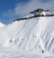 Skiers and snowy slope for freeride with traces of skis, snowboards and avalanches