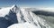 Skiers standing on a snow capped mountain 4k