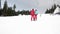 Skiers using ski lift anchor on the mountain. People moving slowly uphill on drag lift on snow covered landscape. Winter sports, s