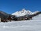 skiers walking down the slopes of a snowy mountain lodge