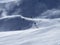 Skiers in wind swept ski piste