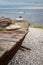 Skiff boat on stone beach by the ocean