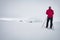 Skiier with red jacket in the mountains during winter.