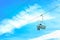 Skiing Adventure: Skier Riding Chairlift against Blue Sky