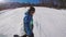 Skiing in the Alps in the winter. A man is rolling on a snowboard on the snow-covered trails of a mountain resort. The