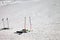Skiing equipment: ski poles, skis on snowy sunlit slope at winter