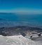 Skiing on the Etna volcano with the background of Taormina Sicilian sea coast of Calabria