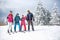 Skiing family enjoying winter vacation on snow in sunny cold day