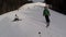 Skiing skiers on the piste in Bukovel ski resort, Ukraine