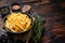 Skilet full of Potato french fries with salt. Wooden background. Top view. Copy space