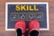 Skill Business concept and kid shoes on on chalkboard and wooden backgroundr