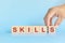 Skill development building and investment and learn new skills concept. Hand stacking wooden blocks with word skills.