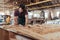 Skilled artisan hand sanding wood in his large workshop