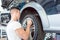 Skilled auto mechanic replacing the rims of a car in a trendy repair shop