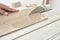 Skilled carpenter cutting a laminate wood, using a circular saw.