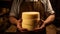 Skilled cheesemaker presents his carefully crafted cheese wheel, a symbol of his dedication to the craft. cheese in