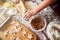 Skilled cook rolling out cookie dough in kitchen